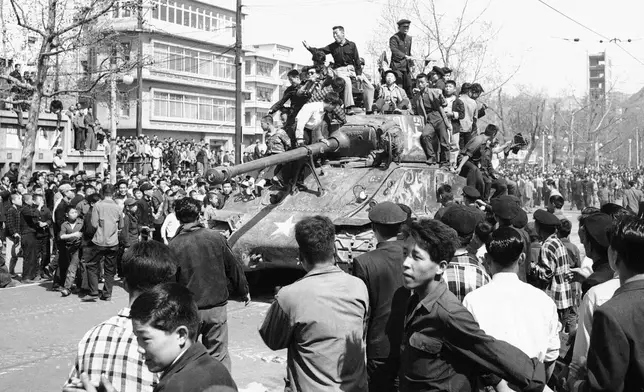 FILE- Jubilant South Koreans surmounted an army tank in Seoul's City Hall Plaza on April 27, 1960 as they celebrated apparent victory over President Syngman Rhee's government. Rhee resigned on April 27 in the face of nationwide demonstrations for democratic reforms and new elections. (AP Photo/File)