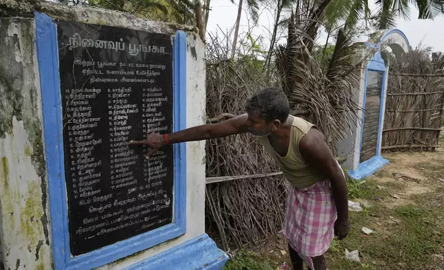 A.Subramaniyam, 57, shows the name of his daughter S. Vinitha, 9, who died during 2004 Tsunami in Seruthur, Nagapattinam, India, Sunday, Dec. 15, 2024. (AP Photo/Mahesh Kumar A.)