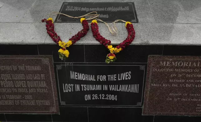 Garlands are kept at the memorial for the victims of the 2004 tsunami, where around 2,000 bodies were buried in Velankanni, Nagapattinam, India, Sunday, Dec. 15, 2024. (AP Photo/Mahesh Kumar A.)