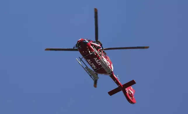 Emergencies helicopter takes Switzerland's Gino Caviezel to the hospital after his fall during an alpine ski, men's World Cup Super G race, in Bormio, Italy, Sunday, Dec. 29, 2024. (AP Photo/Marco Trovati)