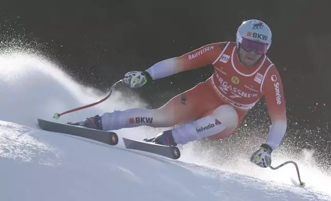 Switzerland's Alexis Monney speeds down the course during an alpine ski, men's World Cup Super G race, in Bormio, Italy, Sunday, Dec. 29, 2024. (AP Photo/Gabriele Facciotti)