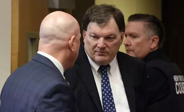 Rex A. Heuermann speaks with his lawyer Michael Brown during a court hearing where he was charged in the killing of Valerie Mack, inside Supreme Court Justice Timothy Mazzei's courtroom at Suffolk County Court in Riverhead, N.Y. on Tuesday, Dec. 17, 2024. (James Carbone/Newsday via AP, Pool)