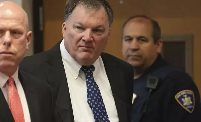 FILE - Rex Heuermann, center, charged in the Gilgo Beach serial killings on Long Island, appears for a hearing, Tuesday, July 30, 2024, at Suffolk County Court in Riverhead, N.Y. (James Carbone/Newsday via AP, File, Pool)