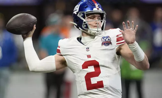 New York Giants quarterback Drew Lock (2) sets back to pass in the first half of an NFL football game against the Atlanta Falcons in Atlanta, Sunday, Dec. 22, 2024. (AP Photo/Mike Stewart)