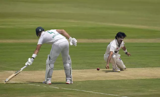 Pakistan's Naseem Shah, right, misfields the ball whilst South Africa's Aiden Markam watches on during day two of the Test cricket match between South Africa and Pakistan, at the Centurion Park in Centurion, South Africa, Friday, Dec. 27, 2024. (AP Photo/Themba Hadebe)