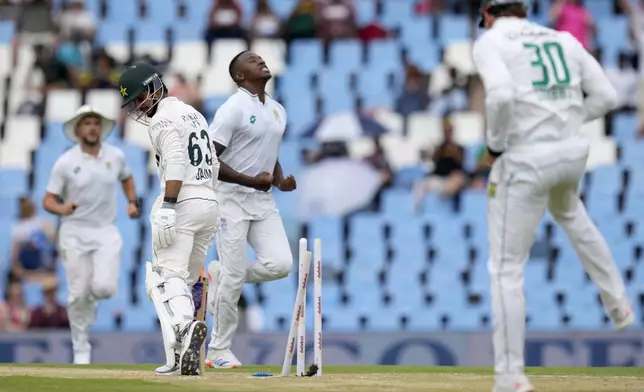 Pakistan's Saim Ayub, left, is bowled out by South Africa's Kagiso Rabada, centre, for 27 runs during day two of the Test cricket match between South Africa and Pakistan, at the Centurion Park in Centurion, South Africa, Friday, Dec. 27, 2024. (AP Photo/Themba Hadebe)