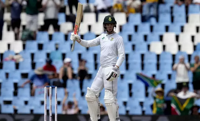 South Africa's Corbin Bosch raises his bat after scoring half century during day two of the Test cricket match between South Africa and Pakistan, at the Centurion Park in Centurion, South Africa, Friday, Dec. 27, 2024. (AP Photo/Themba Hadebe)