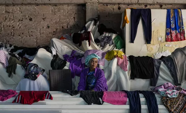 A Sierra Leonean migrant worker stranded in Lebanon, waits to be repatriated back home, as she is sheltered at a former car dealership in Hazmieh, east of Beirut, Lebanon, Friday, Nov. 15, 2024. (AP Photo/Hassan Ammar)