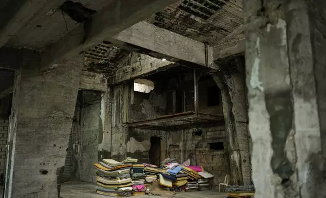 A stack of mattresses used by female Sierra Leonean migrant workers stranded in Lebanon, are stacked up at a former car dealership that was turned into a shelter in Hazmieh, east of Beirut, Lebanon, Wednesday, Dec. 4, 2024. (AP Photo/Hassan Ammar)