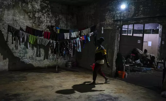 Female Sierra Leonean migrant workers stranded in Lebanon, wait to be repatriated back home, as they are sheltered at a former car dealership shop that was turned into a shelter in Hazmieh, east of Beirut, Lebanon, Friday, Nov. 15, 2024. (AP Photo/Hassan Ammar)