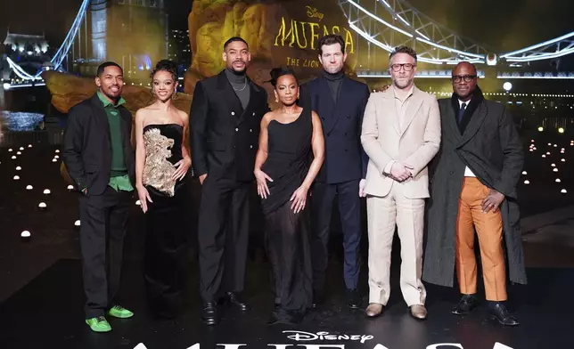 From left to right Kelvin Harrison Jr., Tiffany Boone, Aaron Pierre, Anika Noni Rose, Billy Eichner, Seth Rogan and Barry Jenkins attend a photo call for Mufasa: The Lion King at Potters Field, in London, Wednesday, Dec. 11, 2024. (Ian West/PA via AP)