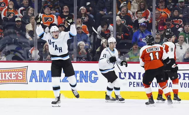 Utah Hockey Club's Juuso Valimaki, left, celebrates after scoring during the second period of an NHL hockey game against the Philadelphia Flyers, Sunday, Dec. 8, 2024, in Philadelphia. (AP Photo/Derik Hamilton)