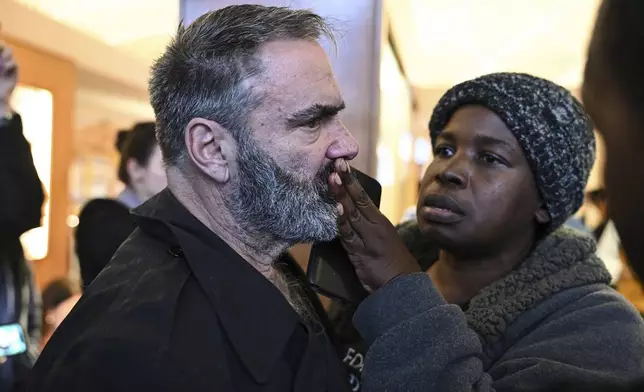 A demonstrator looks on after the Republican-dominated North Carolina House convened to complete the override of Gov. Cooper's veto, Wednesday, Dec. 11, 2024, in Raleigh, N.C. (AP Photo/Matt Kelley)