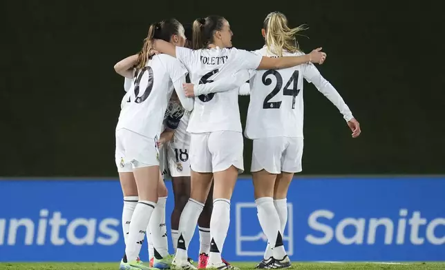 Real Madrid's Caroline Weir, left, celebrates with her teammates after scoring the first goal against Chelsea during the women's Champions League, group B soccer match between Real Madrid and Chelsea at the Alfredo Di Stefano stadium in Madrid, Spain, Tuesday, Dec. 17, 2024. (AP Photo/Manu Fernandez)