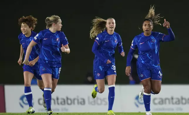 Chelsea's Catarina Macario, right, celebrates after scoring a goal from penalty during the women's Champions League, group B soccer match between Real Madrid and Chelsea at the Alfredo Di Stefano stadium in Madrid, Spain, Tuesday, Dec. 17, 2024. (AP Photo/Manu Fernandez)