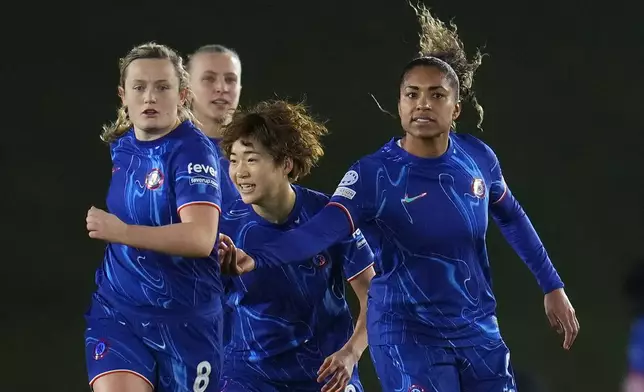 Chelsea's Catarina Macario, right, celebrates with her teammates after scoring a goal from penalty during the women's Champions League, group B soccer match between Real Madrid and Chelsea at the Alfredo Di Stefano stadium in Madrid, Spain, Tuesday, Dec. 17, 2024. (AP Photo/Manu Fernandez)