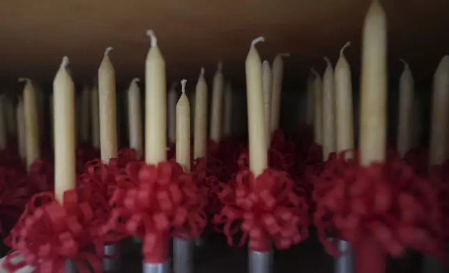 Handmade beeswax candles made by members of Central Moravian church are stored in a closet in Bethlehem, Pa., on Sunday, Dec. 1, 2024, in preparation to be lit during Christmas services. (AP Photo/Luis Andres Henao)