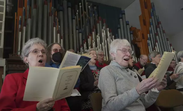 Members of the choir at Central Moravian Church sing at a “Lovefeast” service in Bethlehem, Pa., on Sunday, Dec. 1, 2024. (AP Photo/Luis Andres Henao)