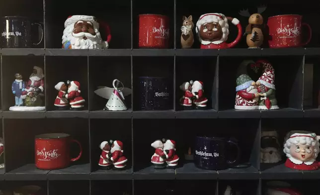 Christmas mugs and decorations on display at a store in Bethlehem, Pa., on Sunday, Friday, Nov. 29, 2024. (AP Photo/Luis Andres Henao)