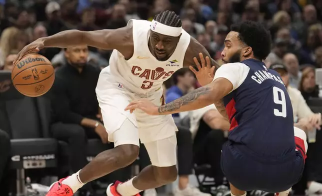 Cleveland Cavaliers guard Caris LeVert (3) drives against Washington Wizards forward Justin Champagnie (9) in the first half of an NBA basketball game, Friday, Dec. 13, 2024, in Cleveland. (AP Photo/Sue Ogrocki)