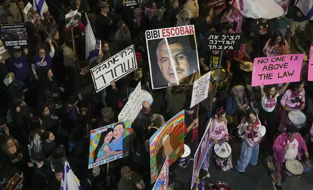 Israelis protest against Prime Minister Benjamin Netanyahu's government and call for the release of hostages held in the Gaza Strip by the Hamas militant group, in Tel Aviv, Israel, Saturday, Dec. 14, 2024. (AP Photo/Tsafrir Abayov)