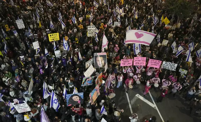 Israelis protest against Prime Minister Benjamin Netanyahu's government and call for the release of hostages held in the Gaza Strip by the Hamas militant group, in Tel Aviv, Israel, Saturday, Dec. 14, 2024. (AP Photo/Tsafrir Abayov)