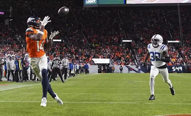 Denver Broncos' Courtland Sutton catches a touchdown pass during the second half of an NFL football game against the Indianapolis Colts Sunday, Dec. 15, 2024, in Denver. (AP Photo/David Zalubowski)