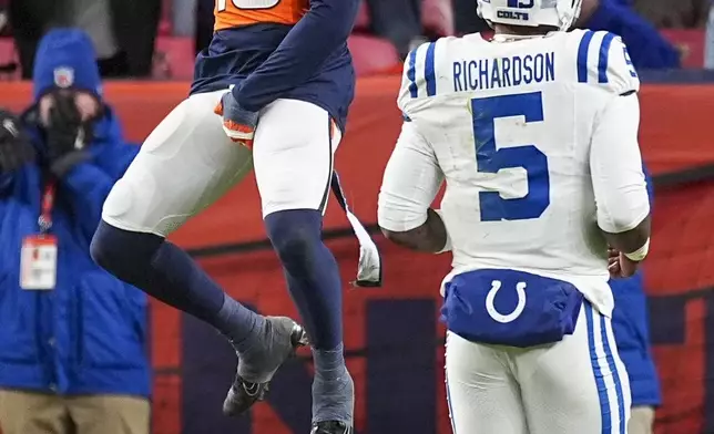 Denver Broncos' Nik Bonitto celebrates his interception and return for a touchdown during the second half of an NFL football game against the Indianapolis Colts Sunday, Dec. 15, 2024, in Denver. (AP Photo/David Zalubowski)