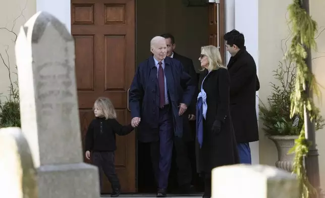 President Joe Biden, first lady Jill Biden and grandson Beau Biden step out of Brandywine Catholic Church in Wilmington, Del., on Wednesday, Dec. 18, 2024. Wednesday marks the 52nd anniversary of the car crash that killed Joe Biden's first wife Neilia Hunter Biden and 13-month-old daughter Naomi. (AP Photo/Ben Curtis)