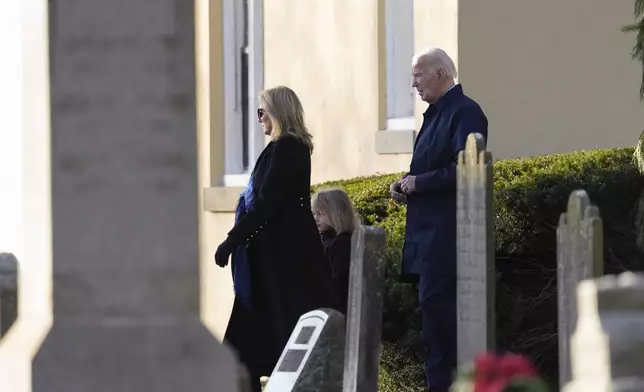 President Joe Biden, first lady Jill Biden and grandson Beau Biden walk from Brandywine Catholic Church in Wilmington, Del., on Wednesday, Dec. 18, 2024. Wednesday marks the 52nd anniversary of the car crash that killed Joe Biden's first wife Neilia Hunter Biden and 13-month-old daughter Naomi. (AP Photo/Ben Curtis)