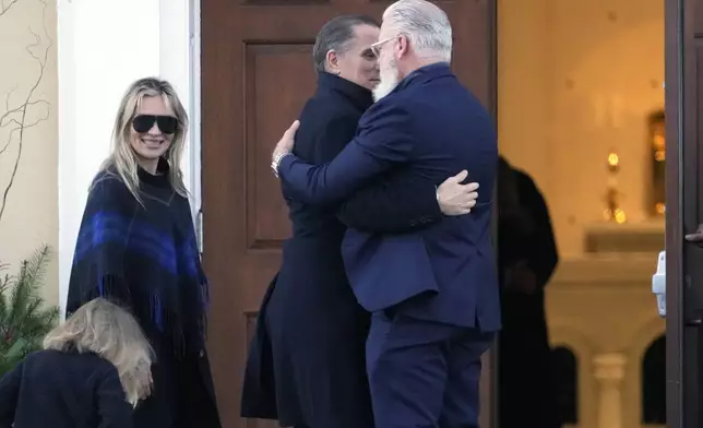 Hunter Biden, his wife Melissa Cohen Biden and their son Beau are greeted as they arrive at St. Joseph on the Brandywine Catholic Church in Wilmington, Del., on Wednesday, Dec. 18, 2024. Wednesday marks the 52nd anniversary of the car crash that killed President Joe Biden's first wife Neilia Hunter Biden and 13-month-old daughter Naomi. (AP Photo/Ben Curtis)