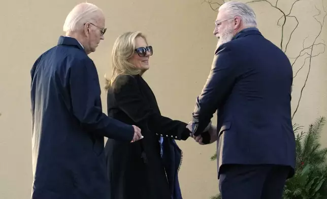 President Joe Biden and first lady Jill Biden are greeted as they arrive at St. Joseph on the Brandywine Catholic Church in Wilmington, Del., on Wednesday, Dec. 18, 2024. Wednesday marks the 52nd anniversary of the car crash that killed Joe Biden's first wife Neilia Hunter Biden and 13-month-old daughter Naomi. (AP Photo/Ben Curtis)