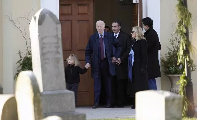 President Joe Biden, first lady Jill Biden and grandson Beau Biden step out of Brandywine Catholic Church in Wilmington, Del., on Wednesday, Dec. 18, 2024. Wednesday marks the 52nd anniversary of the car crash that killed Joe Biden's first wife Neilia Hunter Biden and 13-month-old daughter Naomi. (AP Photo/Ben Curtis)