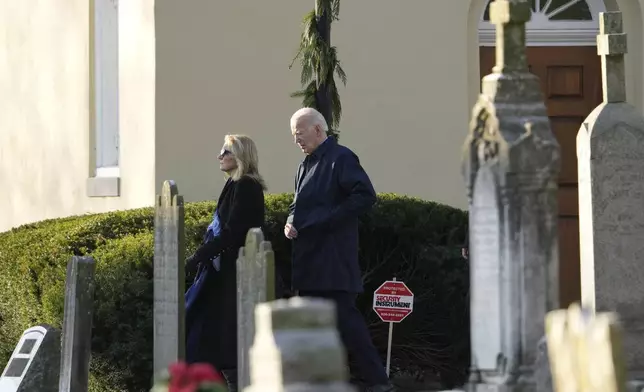 President Joe Biden, first lady Jill Biden walk from Brandywine Catholic Church in Wilmington, Del., on Wednesday, Dec. 18, 2024. Wednesday marks the 52nd anniversary of the car crash that killed Joe Biden's first wife Neilia Hunter Biden and 13-month-old daughter Naomi. (AP Photo/Ben Curtis)