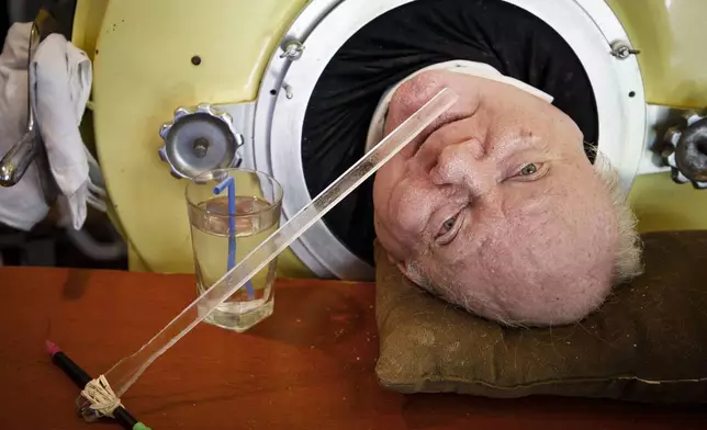 FILE - Attorney Paul Alexander looks out from inside his iron lung at his home in Dallas, April 27, 2018. (Smiley N. Pool/The Dallas Morning News via AP, File)