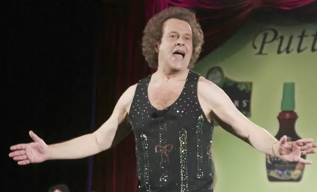 FILE - In this June 2, 2006, file photo, Richard Simmons speaks to the audience before the start of a summer salad fashion show at Grand Central Terminal in New York. (AP Photo/Tina Fineberg, File)