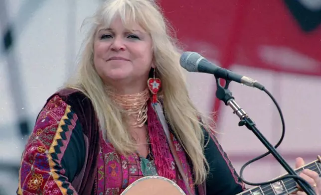 FILE - Melanie Safka, who performed at the original Woodstock decades ago, opens the second day of the festival "Day In The Garden," in Bethel, N.Y., Aug. 15, 1998. (AP Photo/Ken Bizzigotti, File)