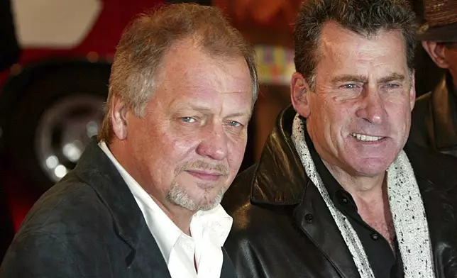 FILE - David Soul, left, and Paul Michael Glaser, stars of the original 1970's "Starsky and Hutch" television series, arrive at the British premiere of the new movie of the same name based on the TV series in London, March 11, 2004. (AP Photo/John D McHugh, File)