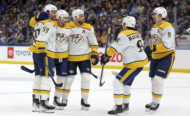 Nashville Predators' Steven Stamkos, second from the left, celebrates with teammates after scoring a goal during the first period of an NHL hockey game against the St. Louis BluesFriday, Dec. 27, 2024, in St. Louis. (AP Photo/Scott Kane)