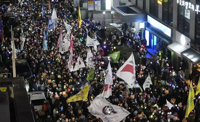 Participants march to the headquarters of the ruling People Power Party during a rally to demand South Korean President Yoon Suk Yeol's impeachment, in Seoul, South Korea, Monday, Dec. 9, 2024. (AP Photo/Ahnn Young-joon)