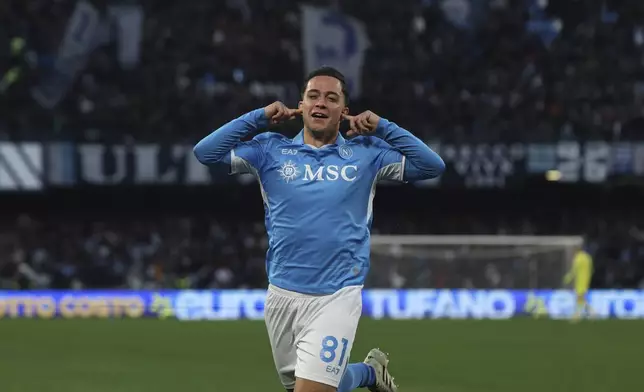 Napoli's Giacomo Raspadori celebrates after scoring the opening goal during the Serie A soccer match between Napoli and Venezia at the Diego Armando Maradona Stadium in Naples, Italy Sunday Dec. 29, 2024. (Alessandro Garofalo/LaPresse via AP)