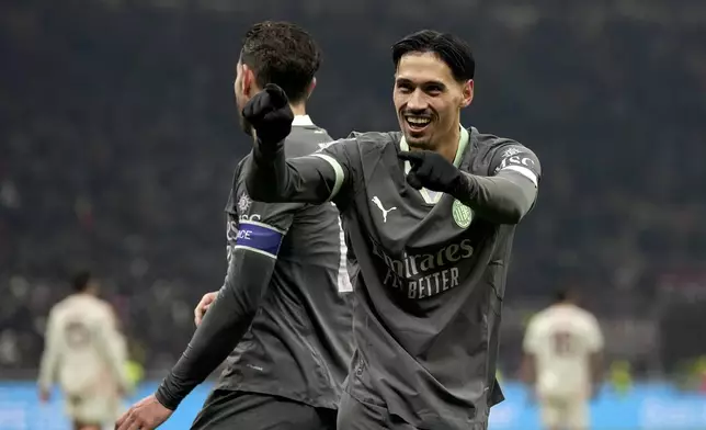 AC Milan's Tijjani Reijnders celebrates scoring his side's opening goal during the Serie A soccer match between AC Milan and Roma at the San Siro stadium, in Milan, Italy, Sunday, Dec. 29, 2024. (AP Photo/Antonio Calanni)