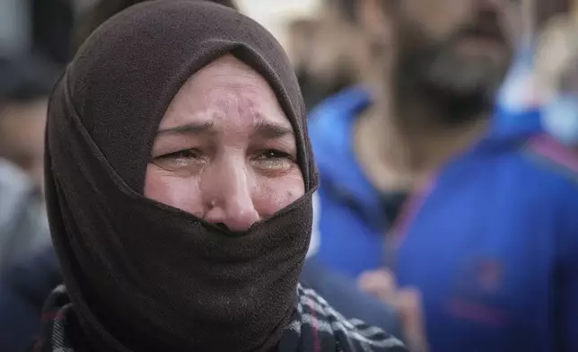 A woman cries during the funeral of Syrian activist Mazen al-Hamada in Damascus Thursday Dec. 12, 2024. Al-Hamad's mangled corpse was found wrapped in a bloody sheet in Saydnaya prison. He had fled to Europe but returned to Syria in 2020 and was imprisoned upon arrival. (AP Photo/Hussein Malla)