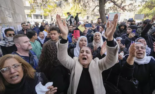 Mourners, including his sister Amal, left, attend the funeral of Syrian activist Mazen al-Hamada in Damascus Thursday Dec. 12, 2024. Al-Hamad's mangled corpse was found wrapped in a bloody sheet in Saydnaya prison. He had fled to Europe but returned to Syria in 2020 and was imprisoned upon arrival. (AP Photo/Hussein Malla)