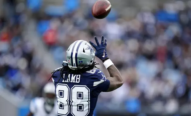 Dallas Cowboys wide receiver CeeDee Lamb catches a pass against the Carolina Panthers during the first half of an NFL football game, Sunday, Dec. 15, 2024, in Charlotte, N.C. (AP Photo/Jacob Kupferman)