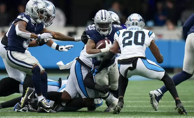 Dallas Cowboys running back Rico Dowdle runs against the Carolina Panthers during the first half of an NFL football game, Sunday, Dec. 15, 2024, in Charlotte, N.C. (AP Photo/Rusty Jones)