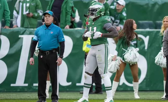 Philadelphia Eagles wide receiver A.J. Brown (11) gestures toward the stands after realizing the football he launched onto the stands is quarterback Tanner McKee's first career touchdown during the second half of an NFL football game against the Dallas Cowboys, Sunday, Dec. 29, 2024, in Philadelphia. (AP Photo/Chris Szagola)