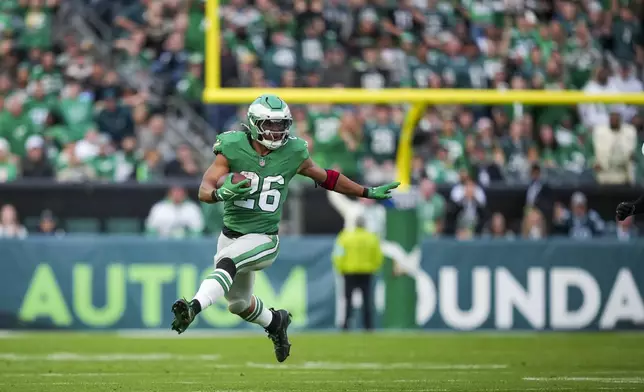 Philadelphia Eagles running back Saquon Barkley (26) runs the ball against the Dallas Cowboys during the second half of an NFL football game, Sunday, Dec. 29, 2024, in Philadelphia. (AP Photo/Matt Slocum)