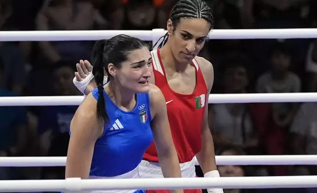 FILE - Algeria's Imane Khelif, right, looks at Italy's Angela Carini, following their women's 66kg preliminary boxing match at the 2024 Summer Olympics, Thursday, Aug. 1, 2024, in Paris, France. (AP Photo/John Locher, File)