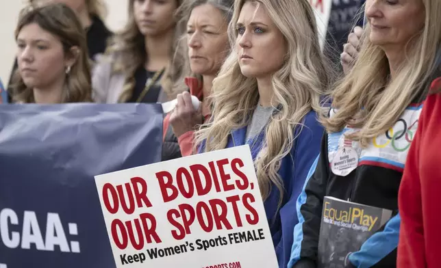 FILE - Former University of Kentucky swimmer Riley Gaines, second from right, stands during a rally, Jan. 12, 2023, outside of the NCAA Convention in San Antonio. (AP Photo/Darren Abate, File)